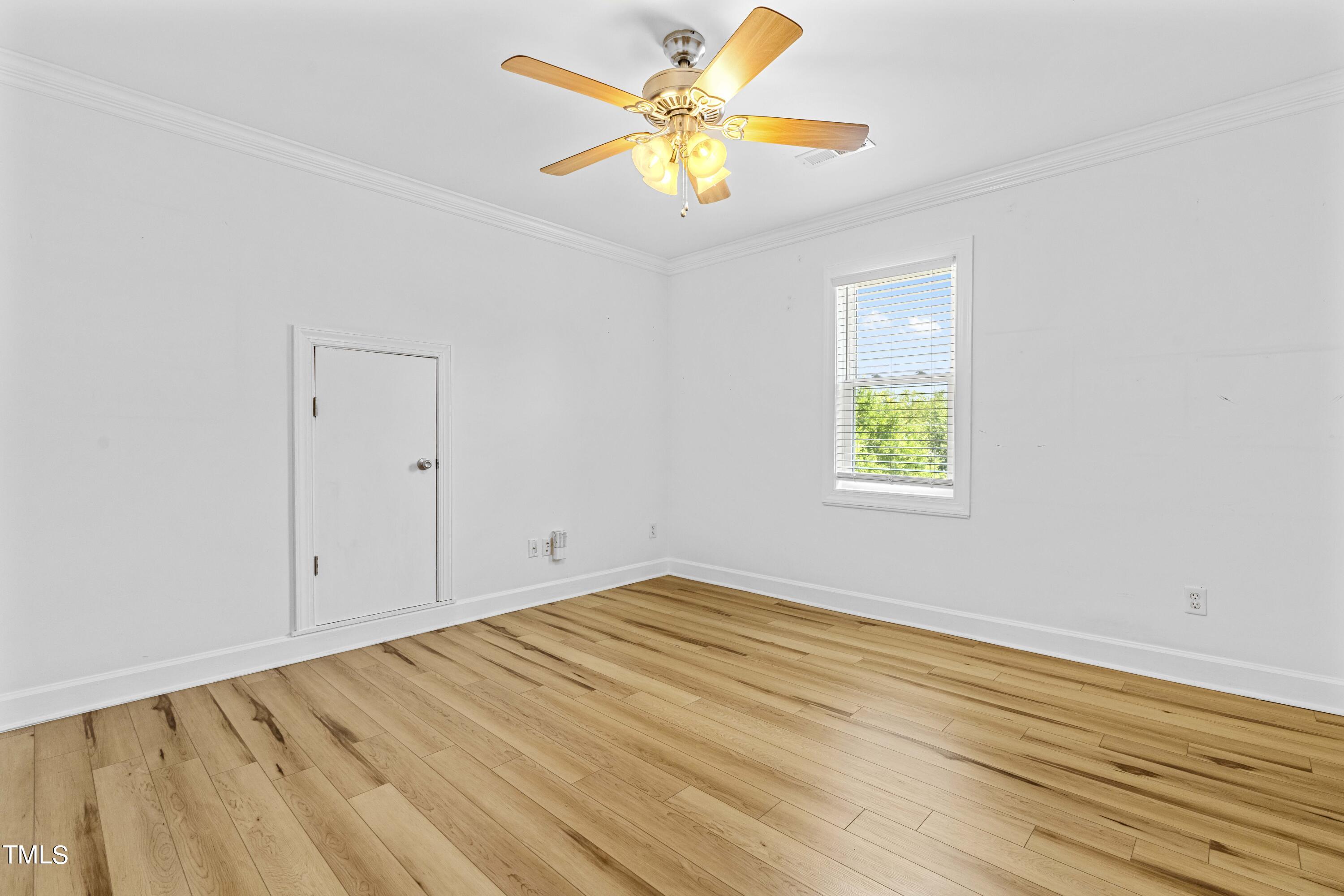 1206 Rainesview Lane Apex, NC 27502 - Photo 21 of 26 wooden floor in an empty room with a window
