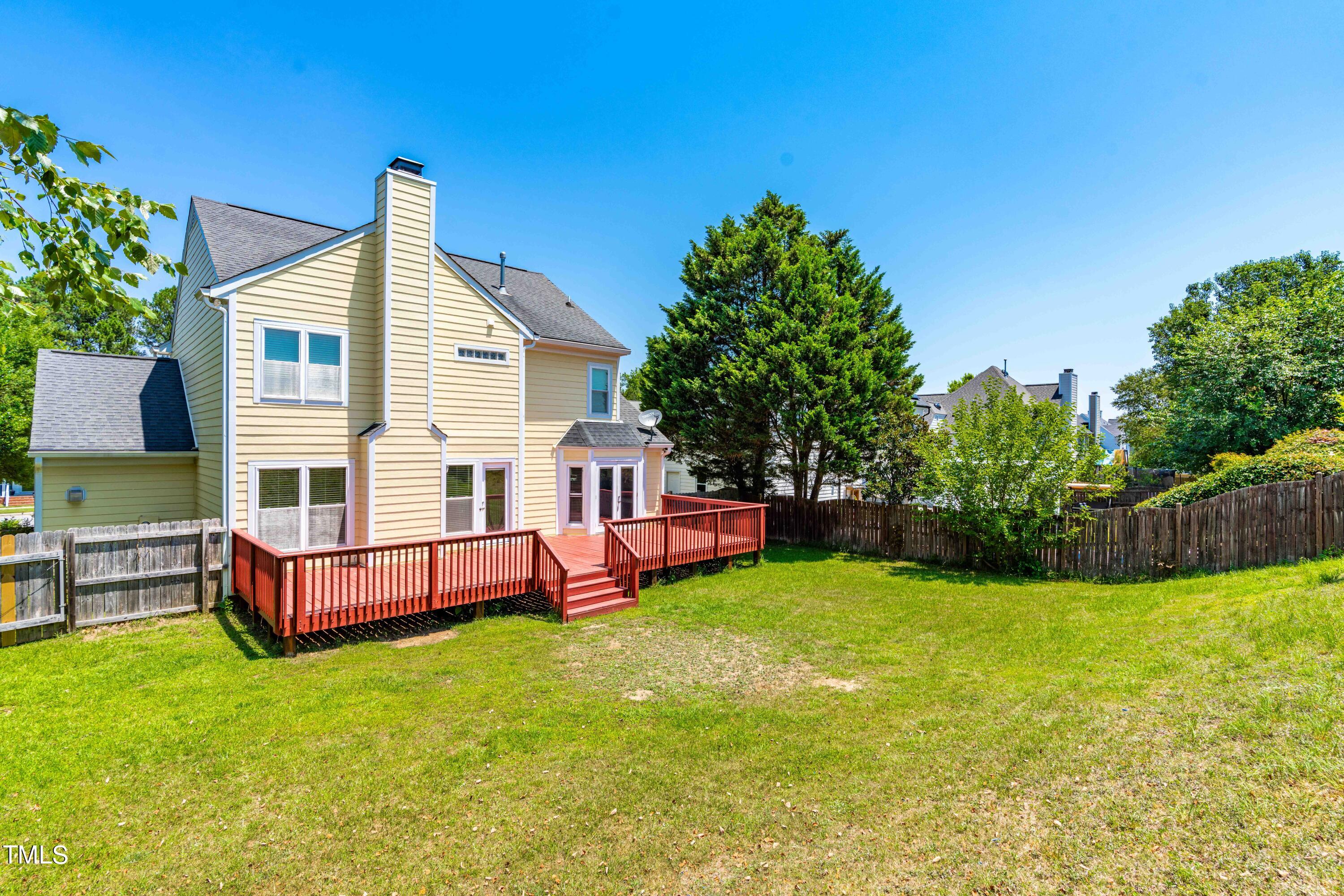 1206 Rainesview Lane Apex, NC 27502 - Photo 23 of 26 a view of a house with a yard and deck
