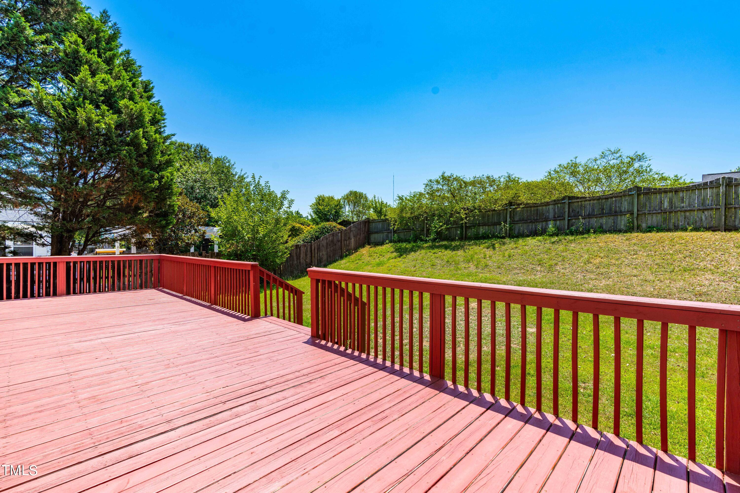 1206 Rainesview Lane Apex, NC 27502 - Photo 24 of 26 a balcony with wooden floor and fence