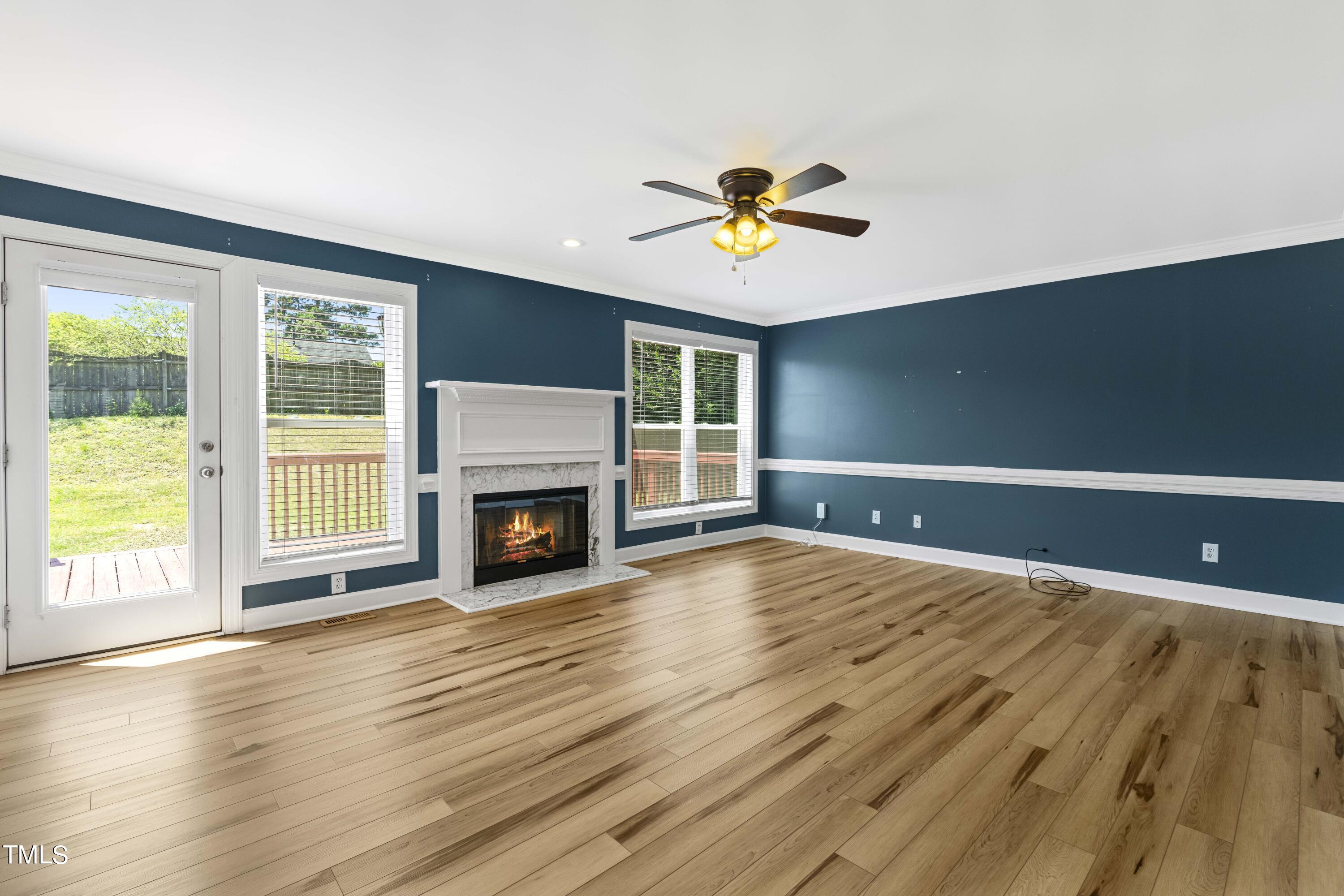 1206 Rainesview Lane Apex, NC 27502 - Photo 6 of 26 a view of an empty room with a window and fireplace