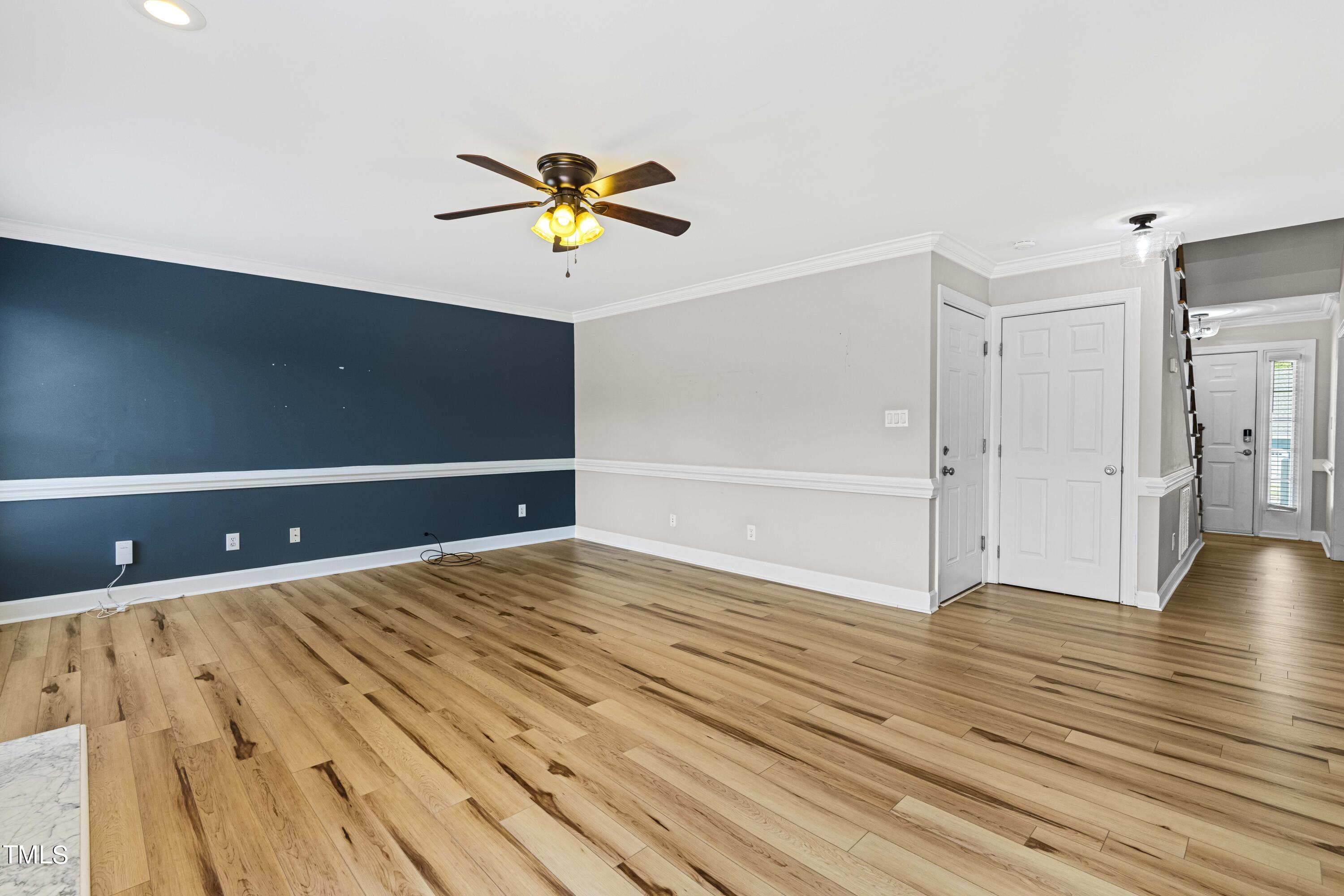 1206 Rainesview Lane Apex, NC 27502 - Photo 8 of 26 a view of an empty room with wooden floor