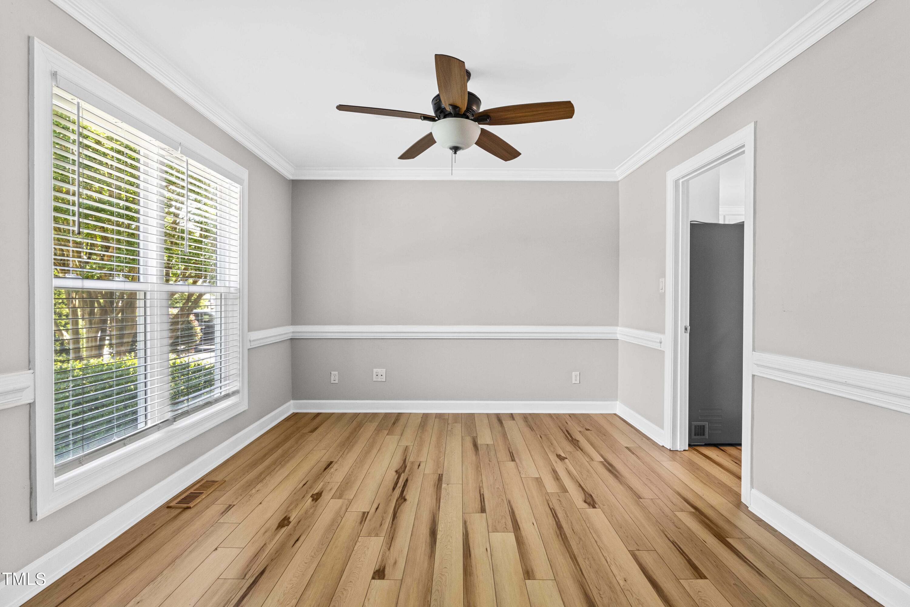 1206 Rainesview Lane Apex, NC 27502 - Photo 10 of 26 a view of empty room with wooden floor and fan
