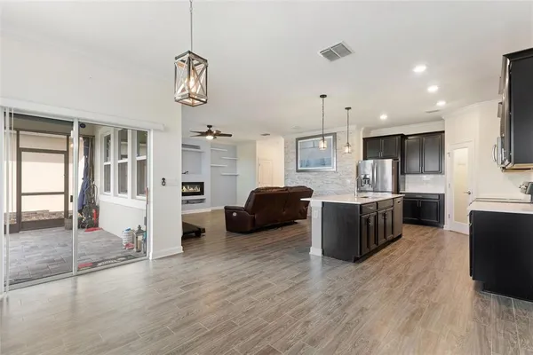 a living room with furniture and a ceiling fan