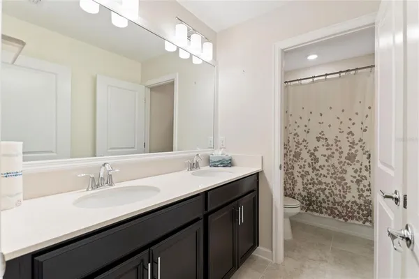 an empty room with closet and windows