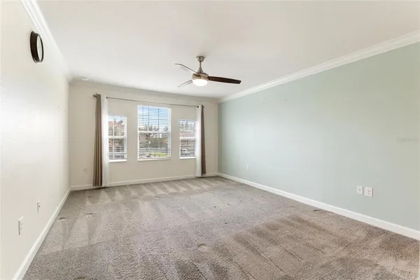 a view of a livingroom with a ceiling fan and entryway