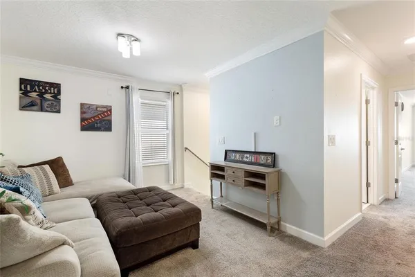 a living room with furniture and outdoor space