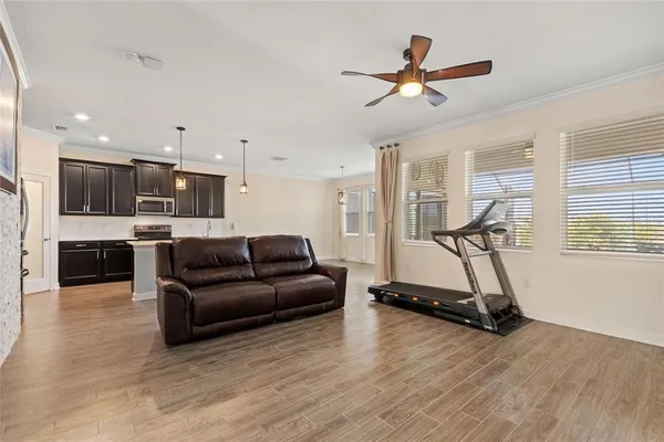 a living room with furniture gym equipment and a wooden floor