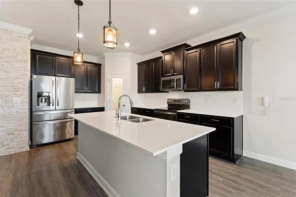a kitchen with stainless steel appliances granite countertop a stove and a wooden floors