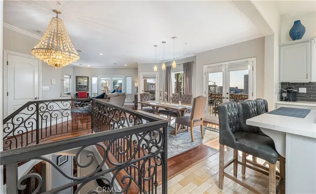 a living room with stainless steel appliances kitchen island granite countertop furniture and a wooden floor