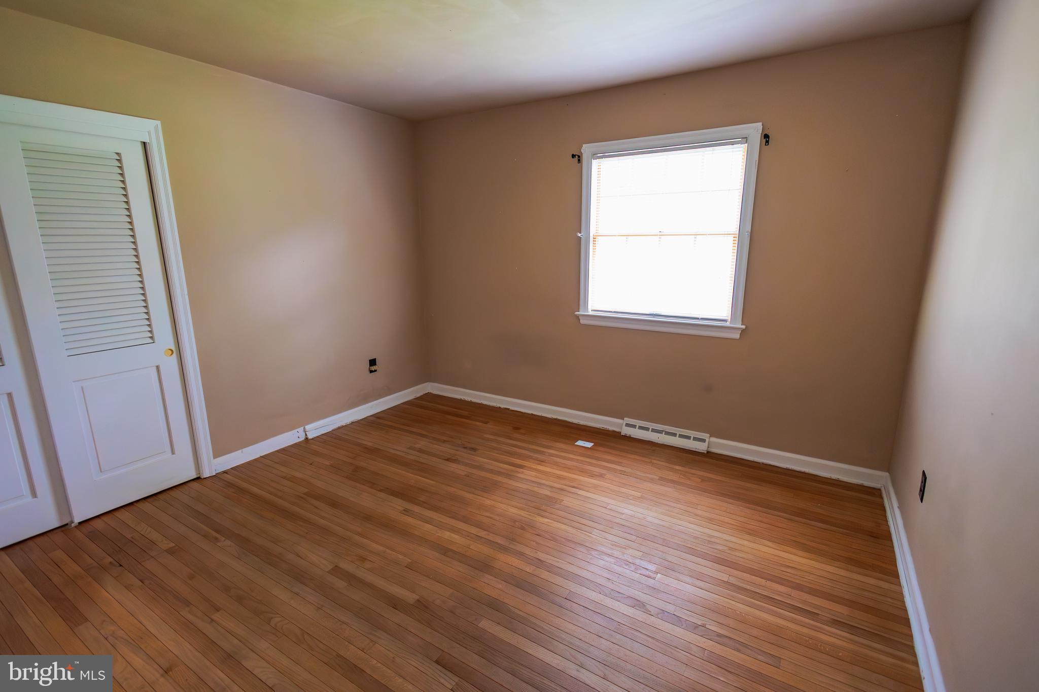 321 Villanova Road Glassboro, NJ 08028 - Photo 16 of 29 an empty room with wooden floor and windows