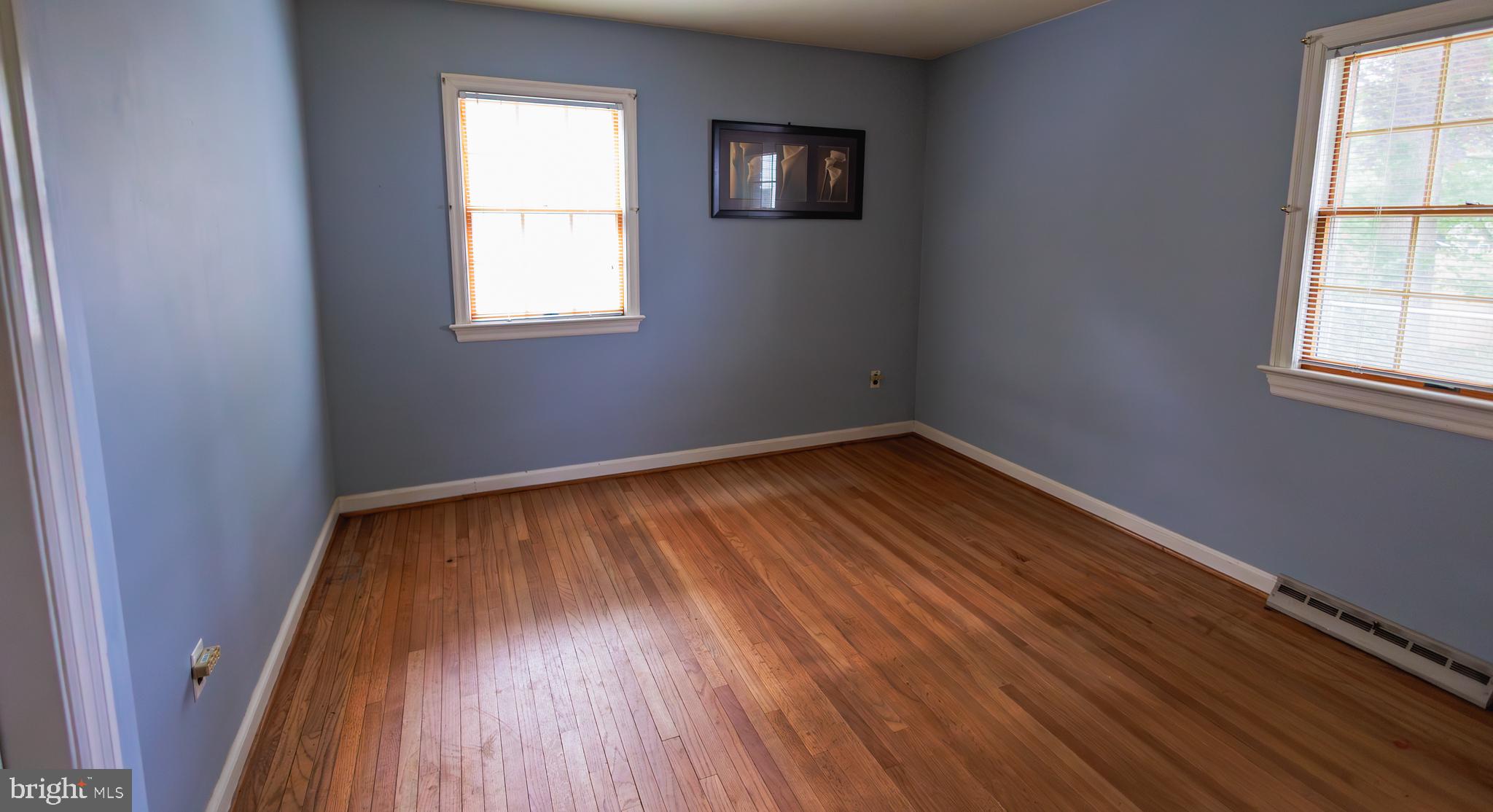 321 Villanova Road Glassboro, NJ 08028 - Photo 20 of 29 an empty room with wooden floor and windows