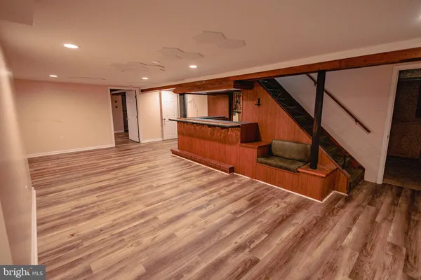 a view of entryway with wooden floor and stairs