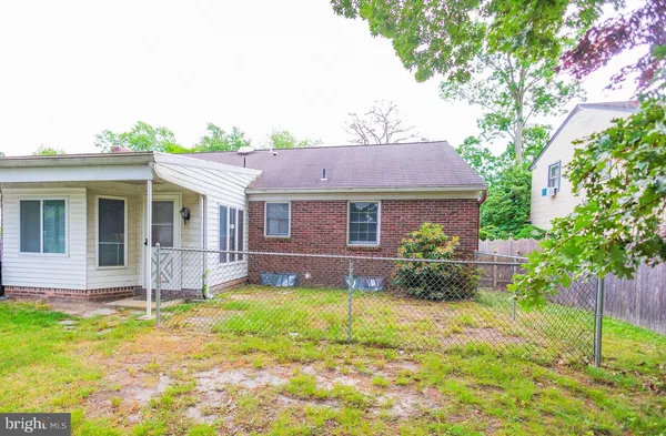 a view of a house with a yard and sitting area