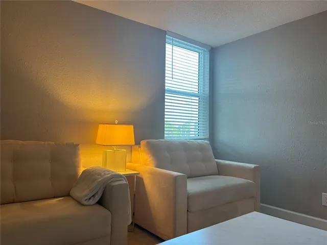 a living room with a couch and a night stand