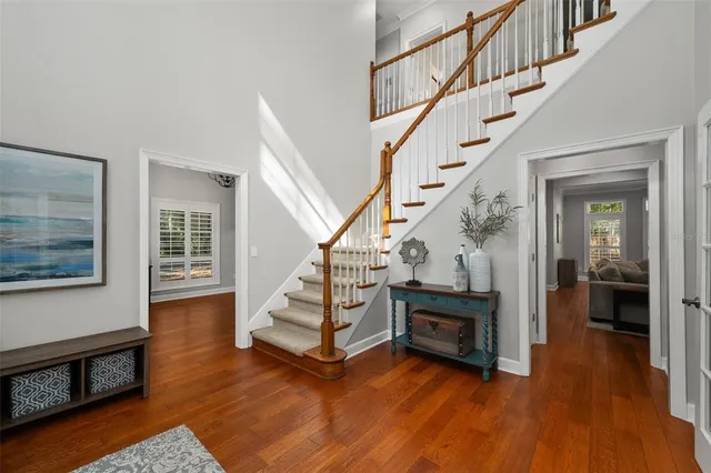 a view of entryway and hall with wooden floor