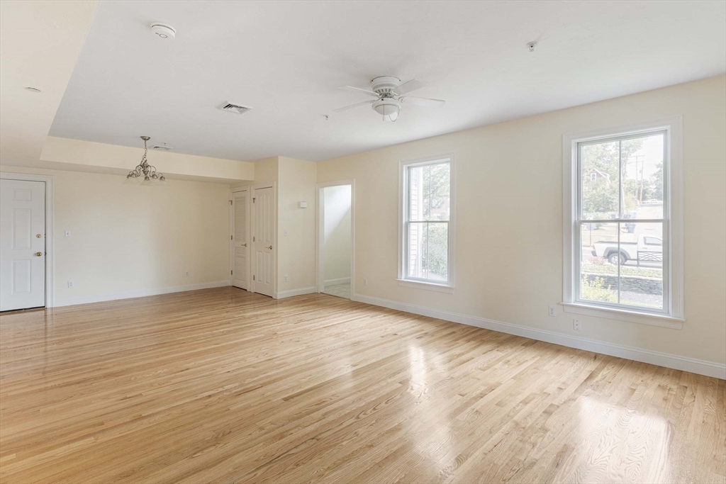 756 Washington Street, Unit A Canton, MA 02021 - Photo 12 of 20 an empty room with wooden floor and windows