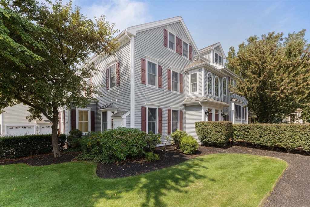 756 Washington Street, Unit A Canton, MA 02021 - Photo 15 of 20 a front view of a house with garden and trees