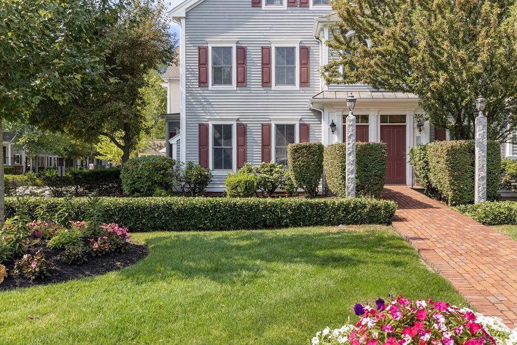 756 Washington Street, Unit A Canton, MA 02021 - Photo 19 of 20 a front view of a house with a garden