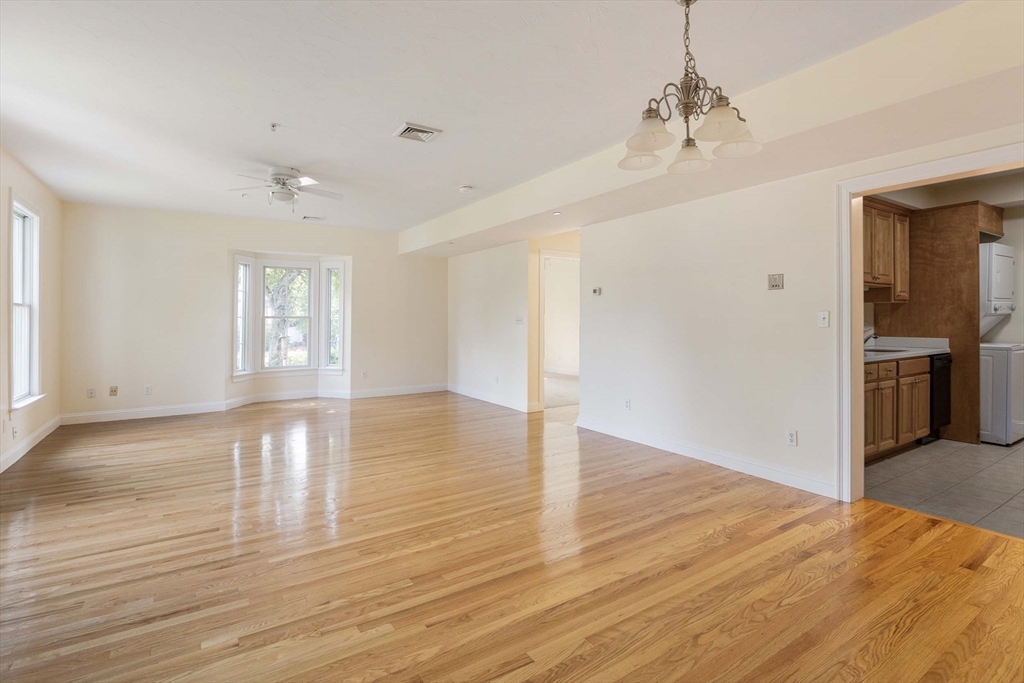756 Washington Street, Unit A Canton, MA 02021 - Photo 4 of 20 a view of an empty room with window and wooden floor