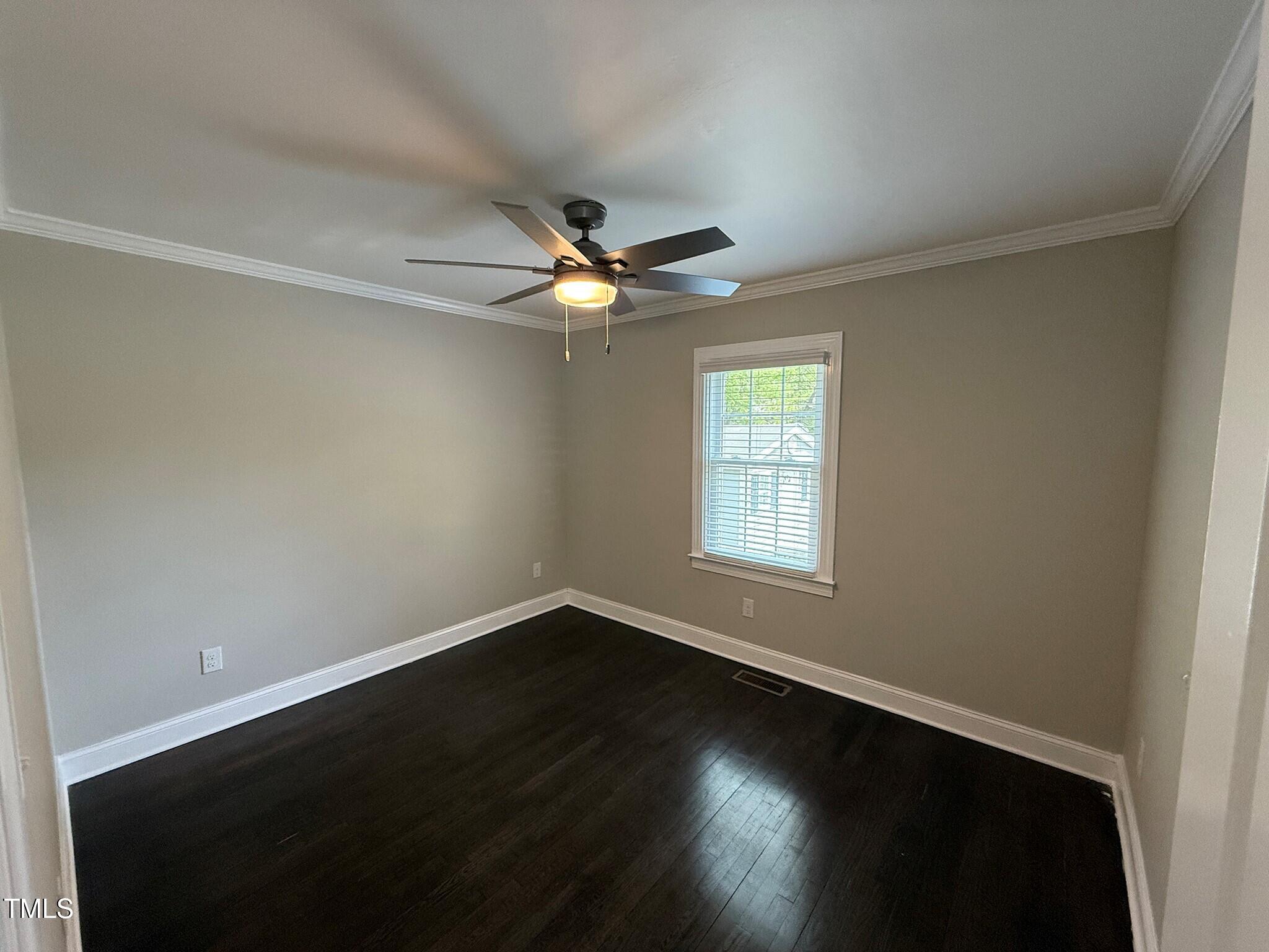215 Walnut Street Cary, NC 27511 - Photo 14 of 33 an empty room with wooden floor and windows
