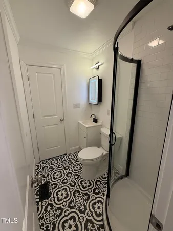 a bathroom with a toilet and a shower
