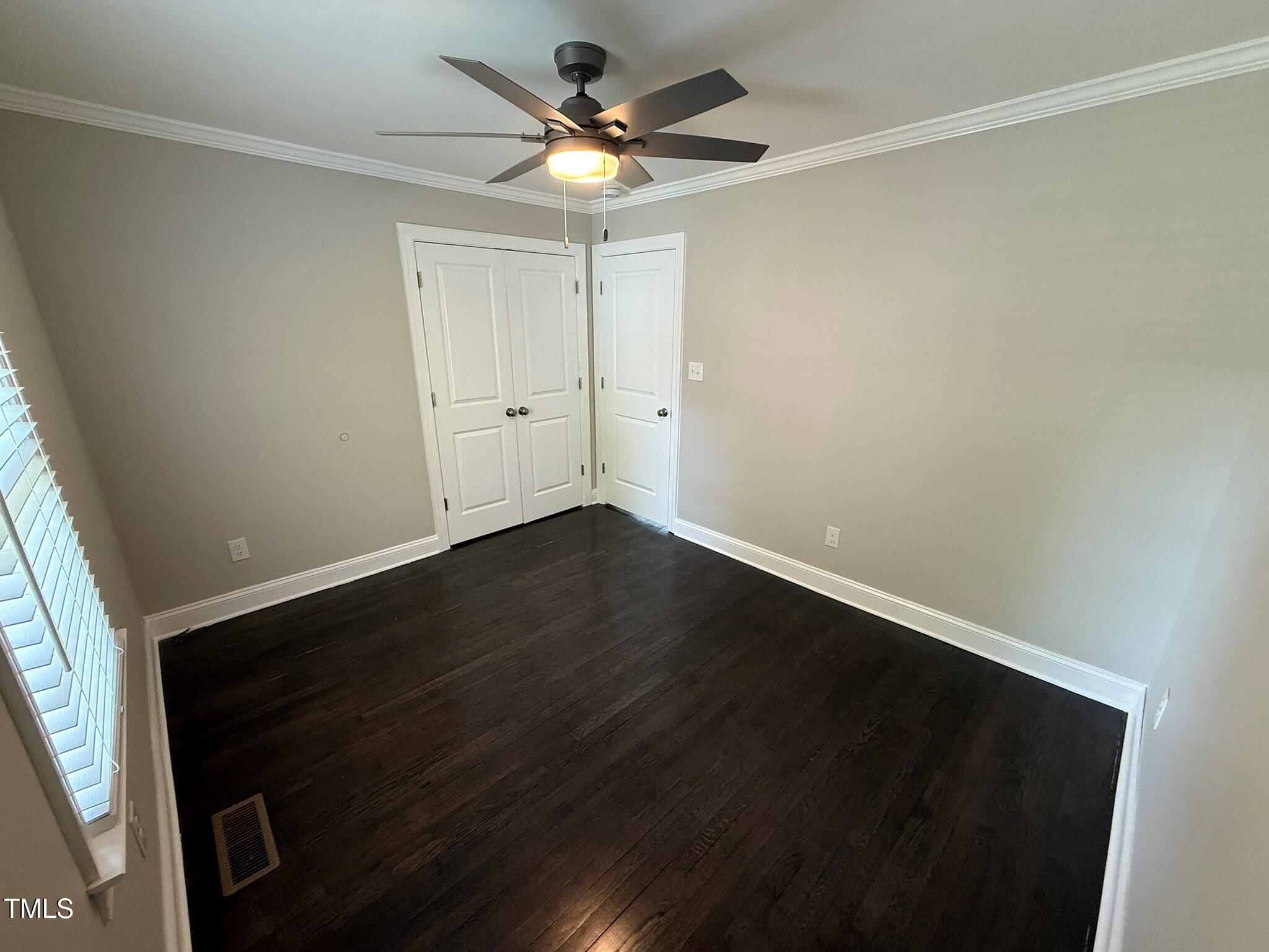 215 Walnut Street Cary, NC 27511 - Photo 18 of 33 an empty room with wooden floor and windows