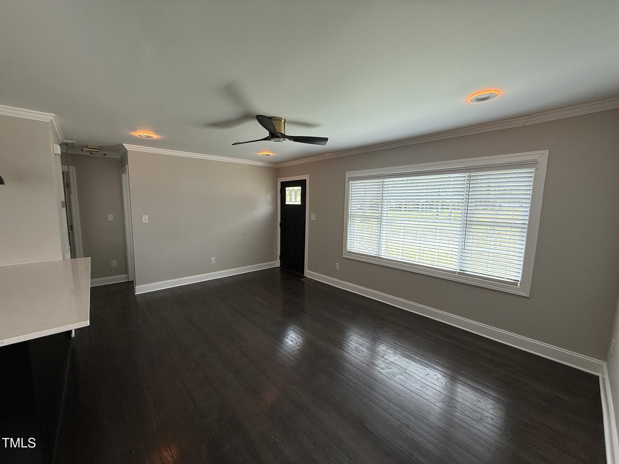 215 Walnut Street Cary, NC 27511 - Photo 2 of 33 a view of an empty room with wooden floor and a window