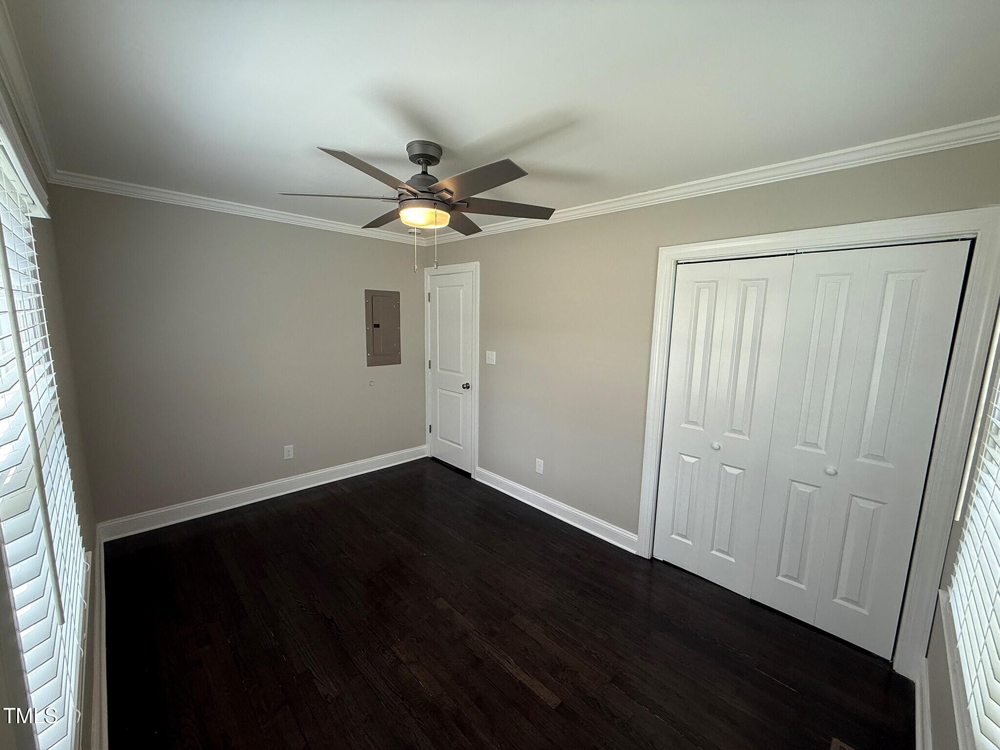 215 Walnut Street Cary, NC 27511 - Photo 21 of 33 an empty room with wooden floor fan and windows