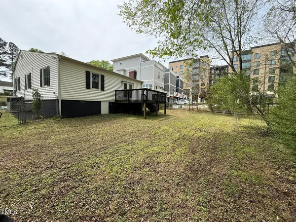 a view of a house with a yard and sitting area