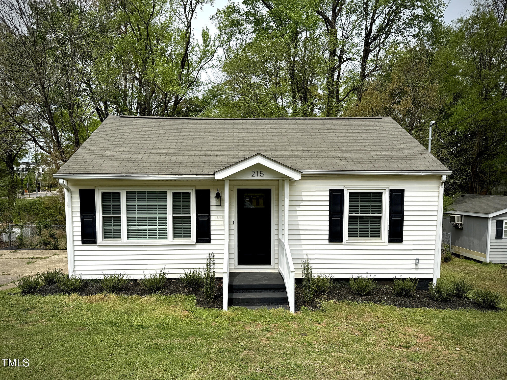 215 Walnut Street Cary, NC 27511 - Photo 32 of 33 a view of a house with a yard and plants