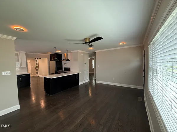 a living room with hard wood floors and a window
