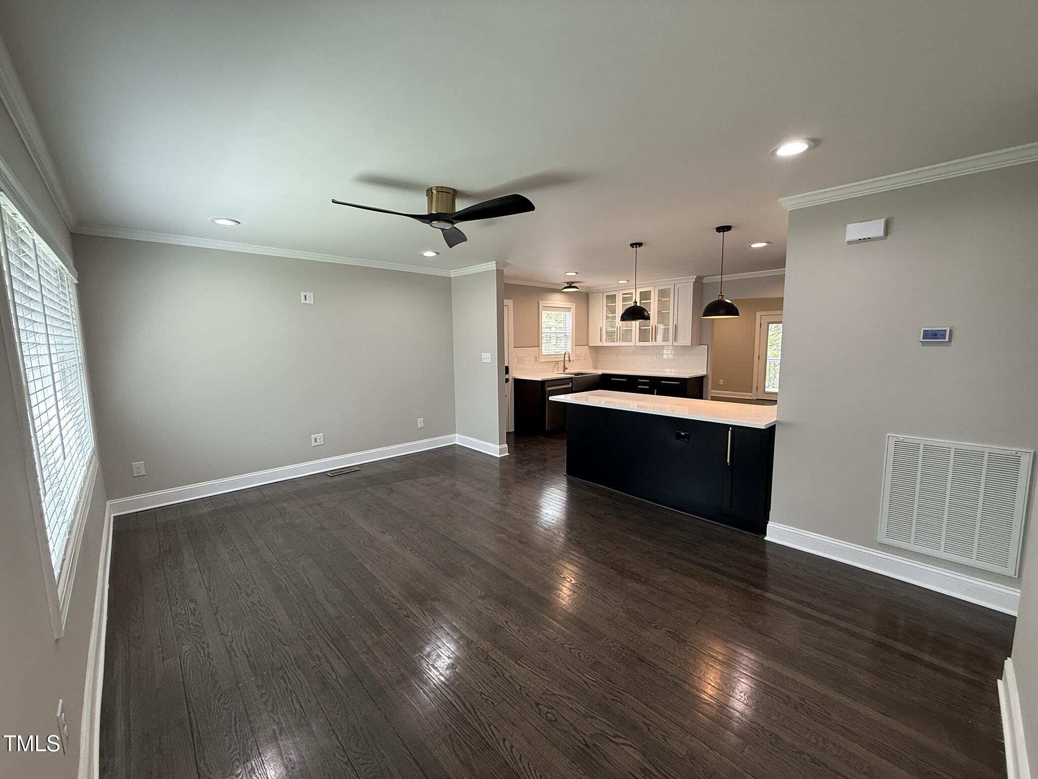 215 Walnut Street Cary, NC 27511 - Photo 5 of 33 a large kitchen with cabinets wooden floor and stainless steel appliances