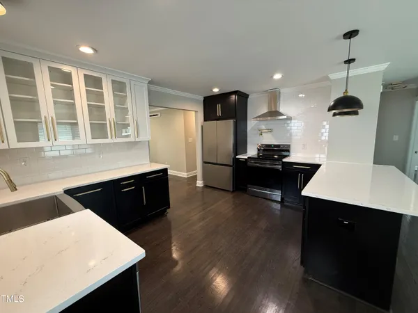 a large kitchen with kitchen island a sink stainless steel appliances and cabinets