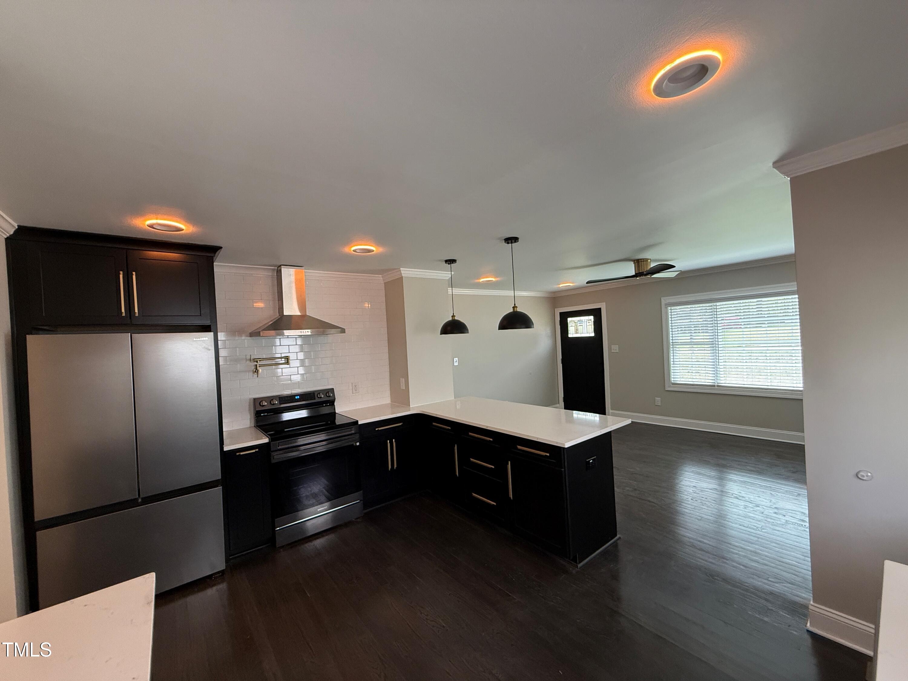 215 Walnut Street Cary, NC 27511 - Photo 8 of 33 a kitchen with stainless steel appliances a refrigerator sink and stove