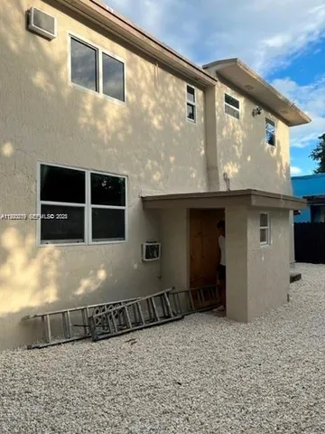a view of a hallway with wooden floor and closet area