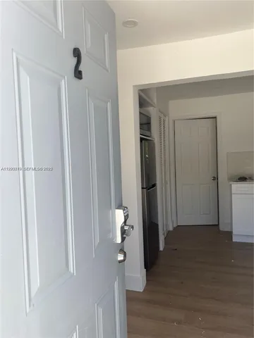 an empty room with wooden floor and closet
