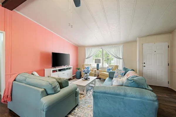 a living room with furniture and a flat screen tv