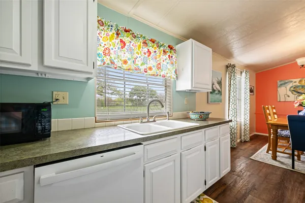 a kitchen with sink and cabinets