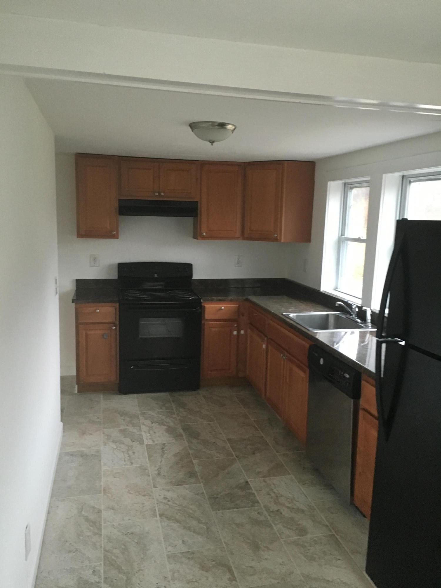 116 Iyannough Road Hyannis, MA 02601 - Photo 3 of 7 a kitchen with stainless steel appliances granite countertop a sink stove and refrigerator