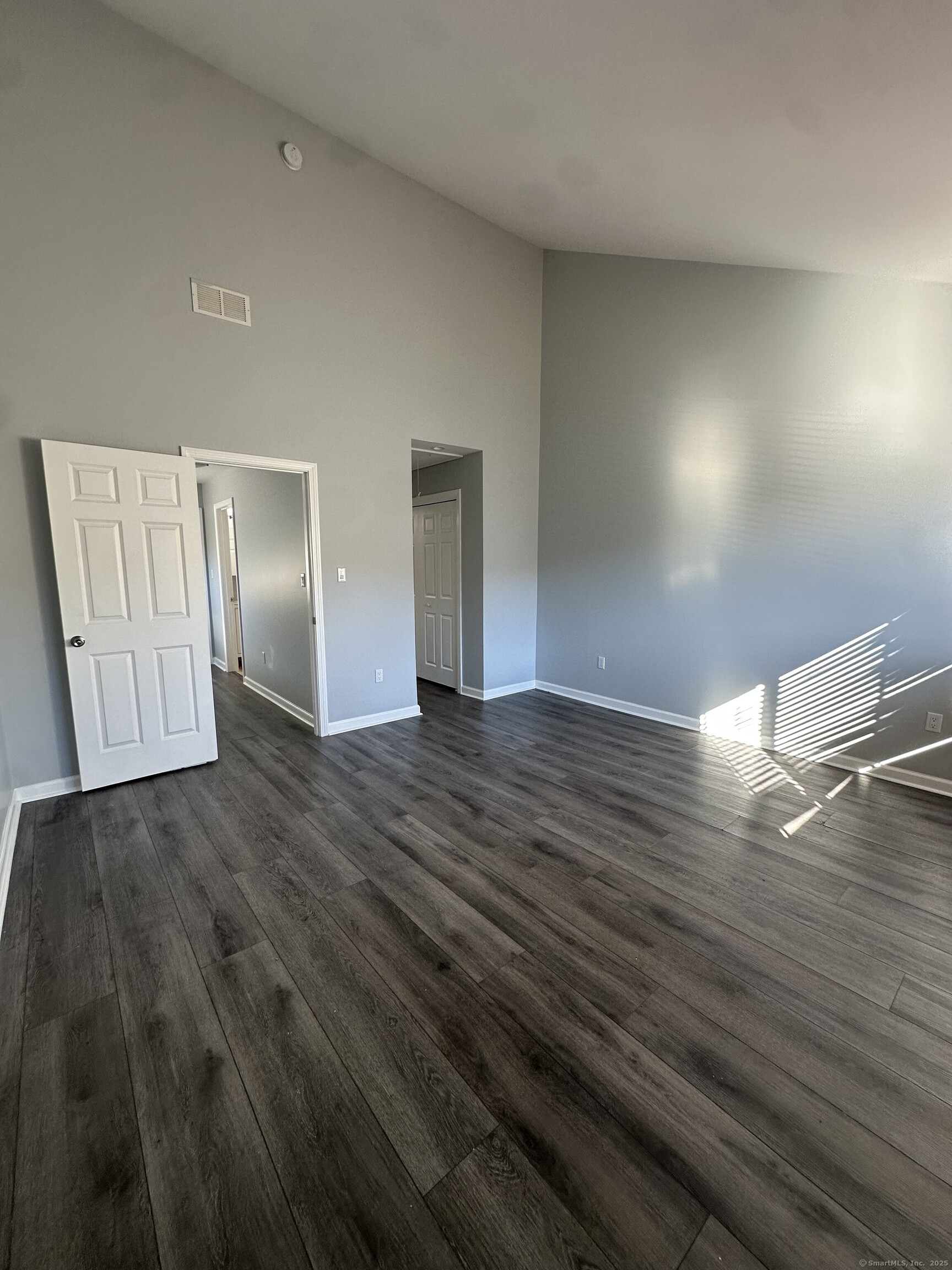 13 Deer Run, Unit 13 Bethel, CT 06801 - Photo 13 of 22 a view of empty room with wooden floor