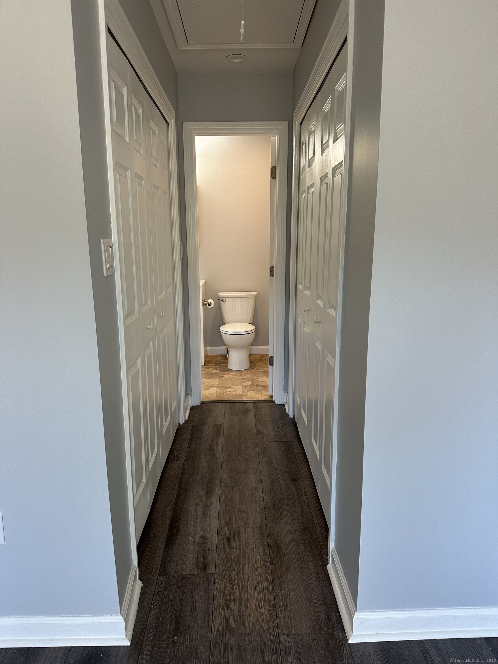 13 Deer Run, Unit 13 Bethel, CT 06801 - Photo 15 of 22 a view of a hallway with wooden floor and a bathroom