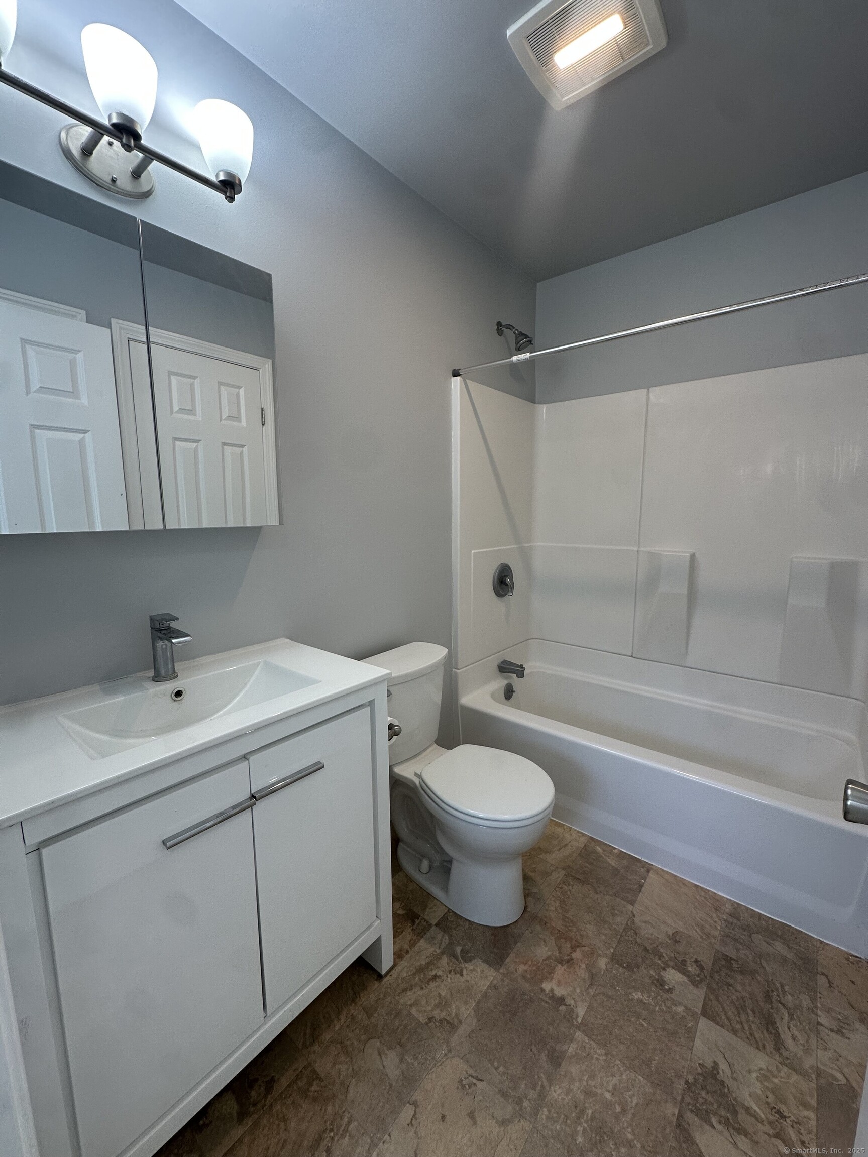 13 Deer Run, Unit 13 Bethel, CT 06801 - Photo 16 of 22 a bathroom with a toilet a sink a mirror and a bathtub