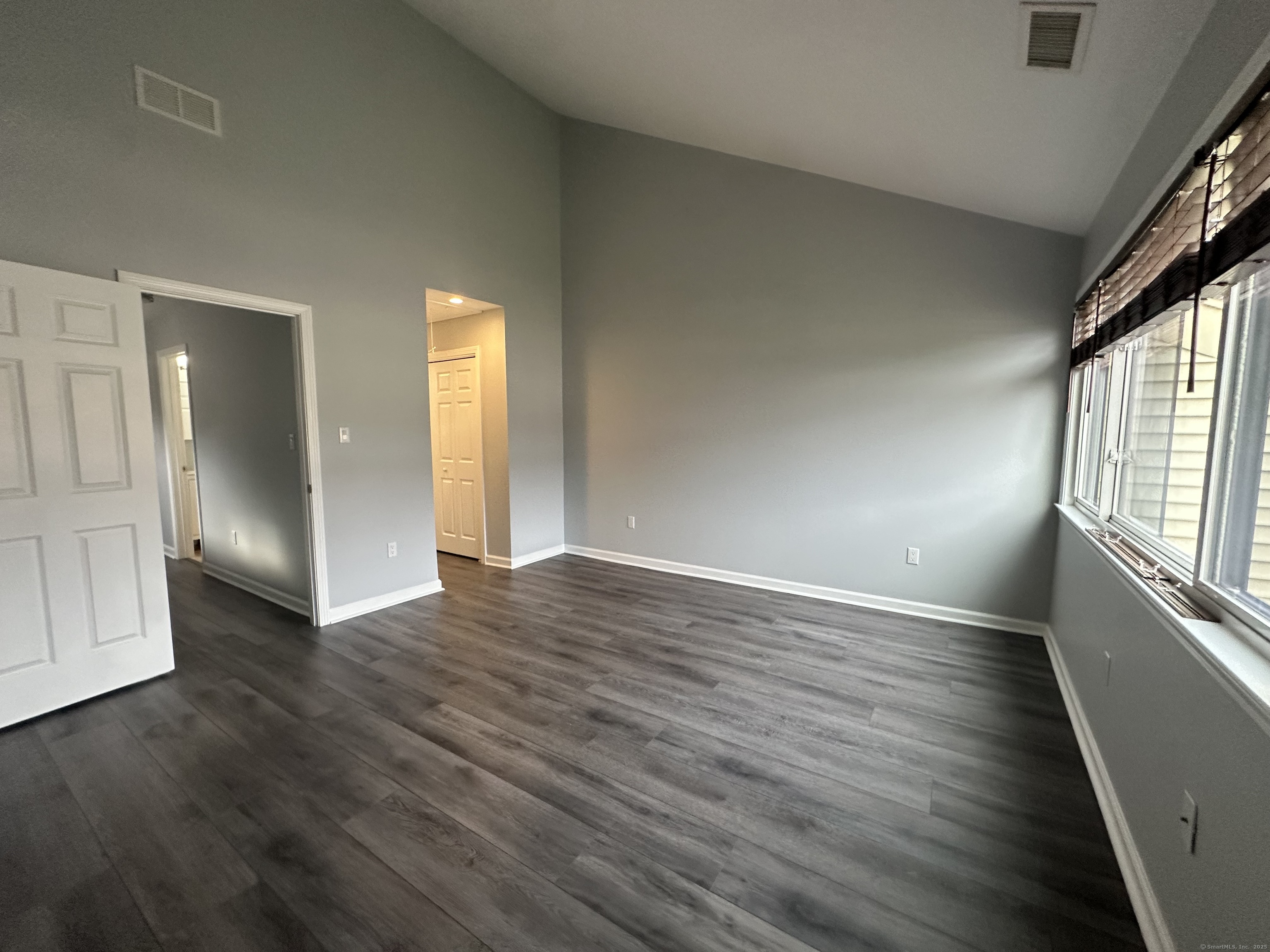 13 Deer Run, Unit 13 Bethel, CT 06801 - Photo 21 of 22 an empty room with wooden floor and windows