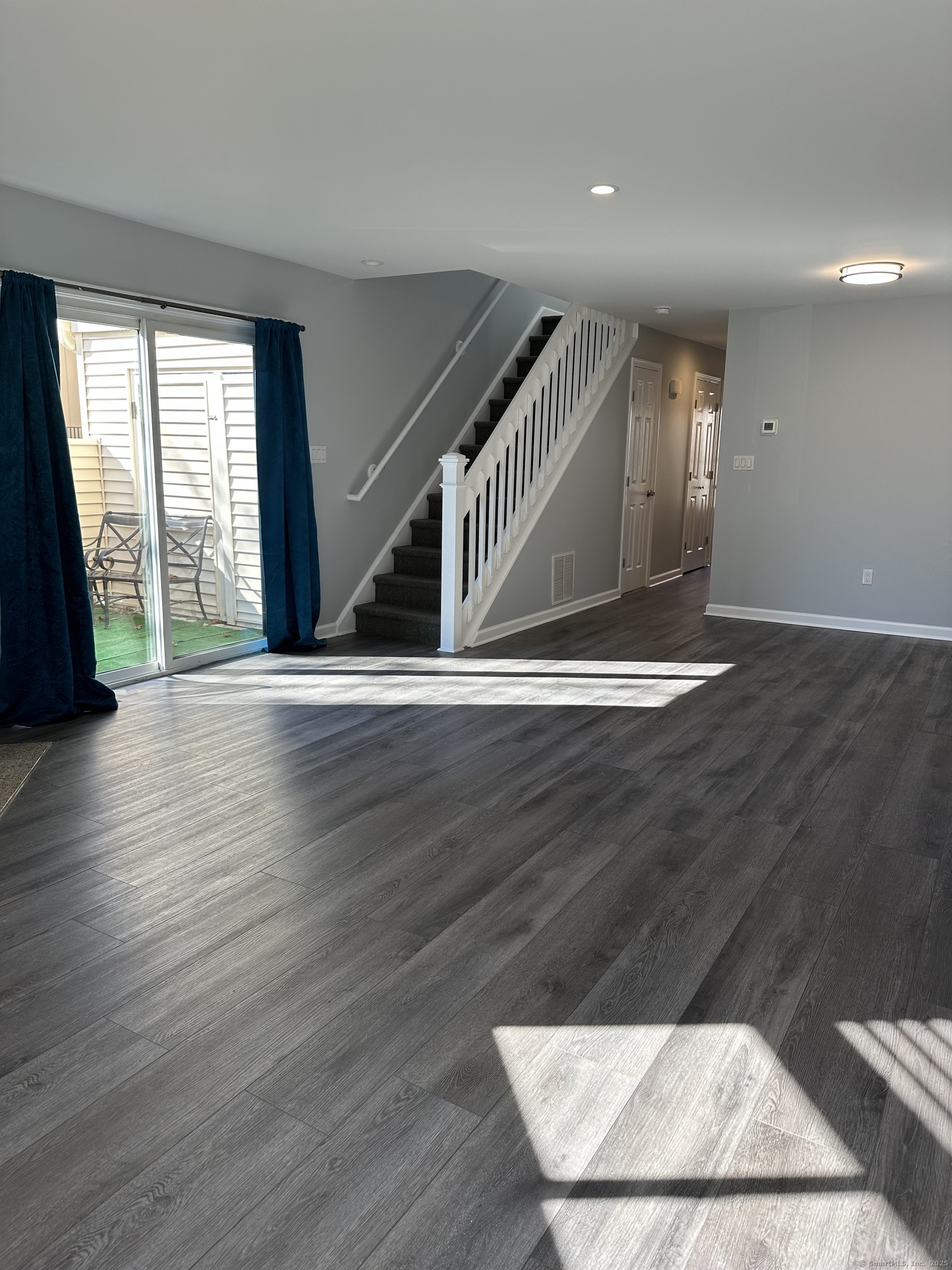 13 Deer Run, Unit 13 Bethel, CT 06801 - Photo 4 of 22 an empty room with wooden floor and windows