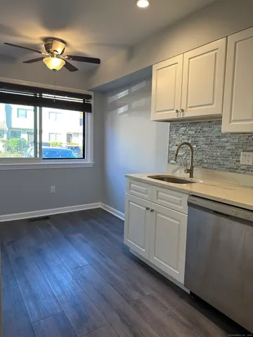 a kitchen with sink cabinets and wooden floor