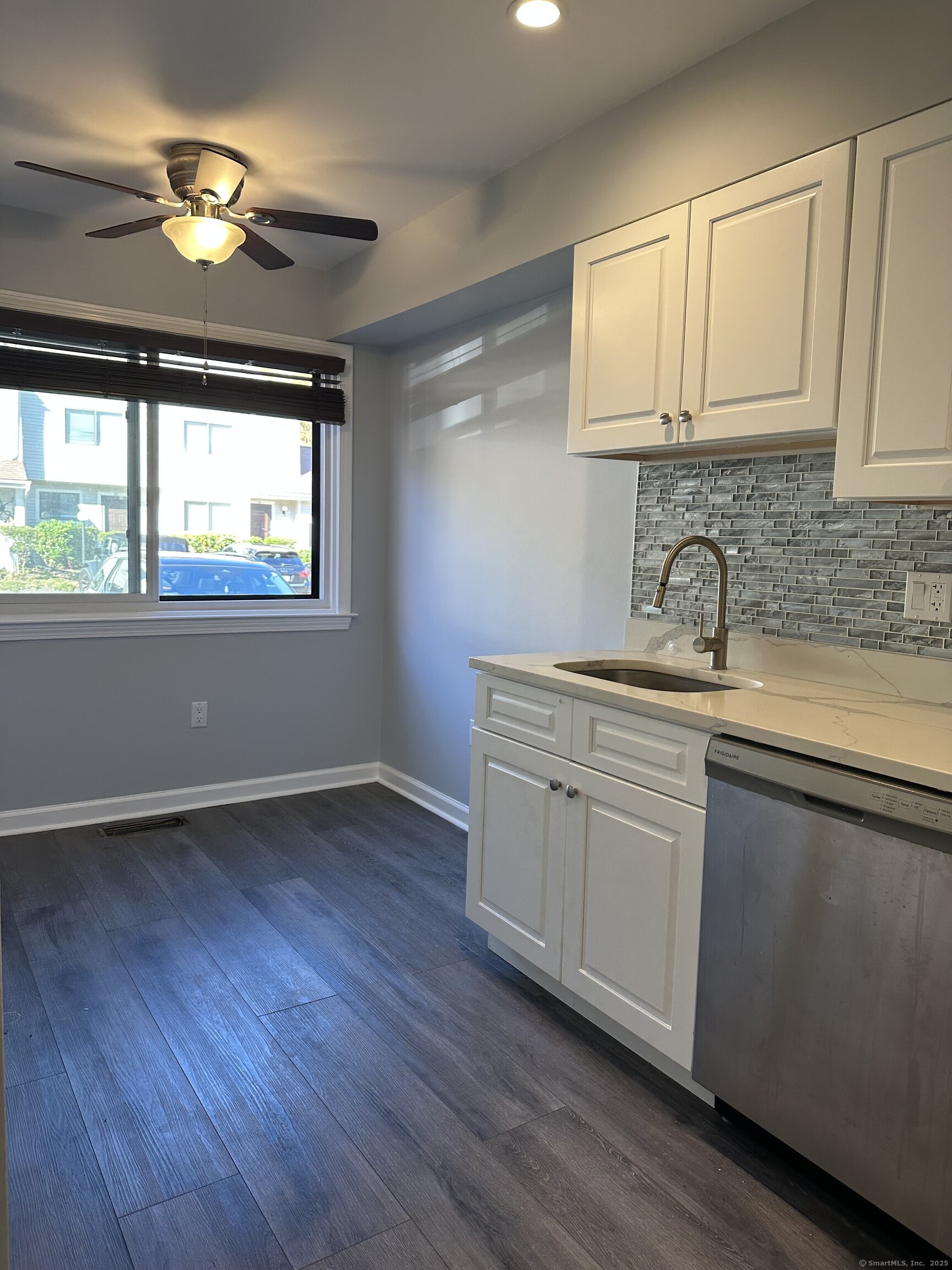13 Deer Run, Unit 13 Bethel, CT 06801 - Photo 7 of 22 a kitchen with sink cabinets and wooden floor