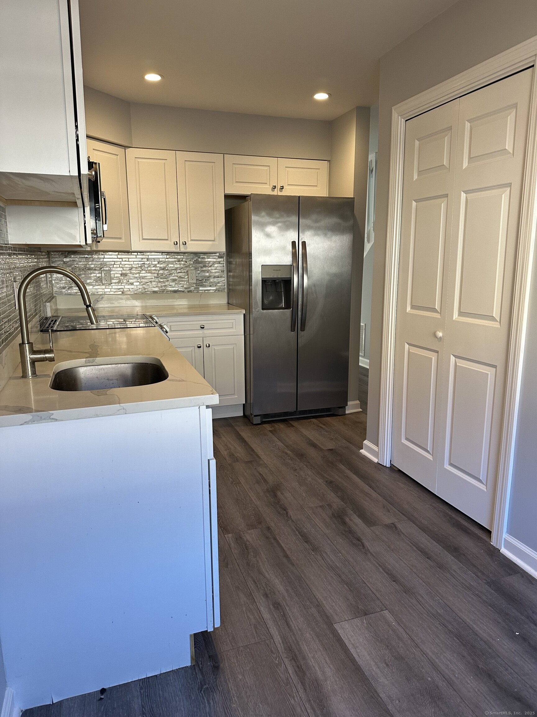 13 Deer Run, Unit 13 Bethel, CT 06801 - Photo 8 of 22 a kitchen with a refrigerator sink and cabinets