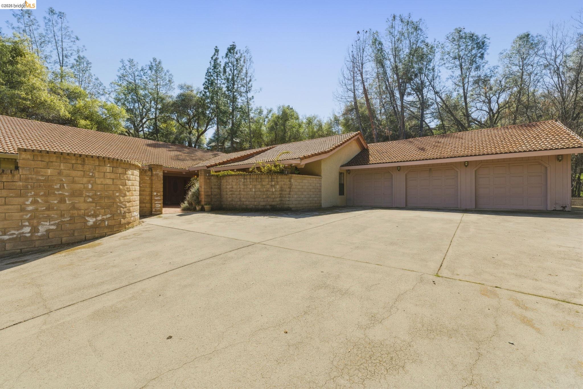23608 Porcina Way Columbia, CA 95310 - Photo 9 of 51 View of side of property with a tiled roof, concrete driveway, and a garage