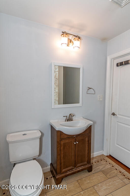 755 White Oak Road Cresco, PA 18326 - Photo 30 of 50 a bathroom with a toilet sink and mirror