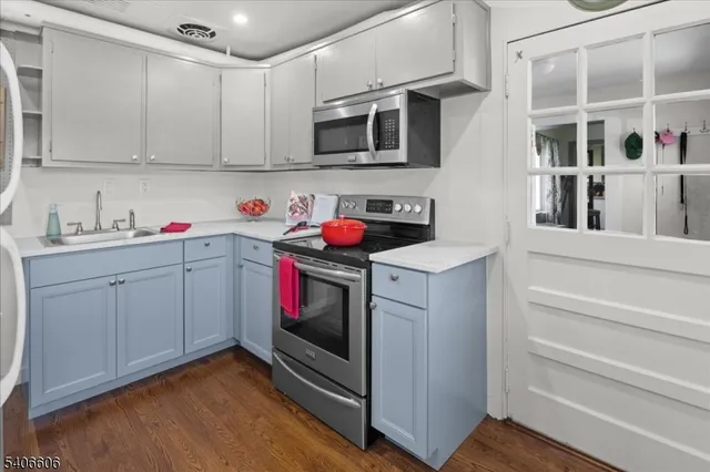 a utility room with sink dryer and washer